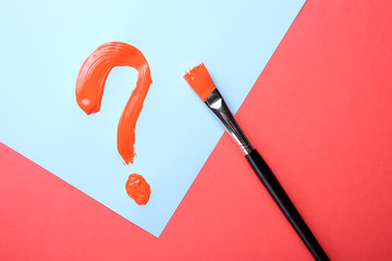 Red question mark painted on blue background. Question mark on blue an red.
