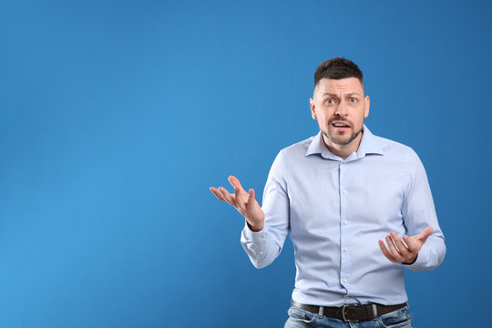 Emotional Man On Blue Background, Space For Text