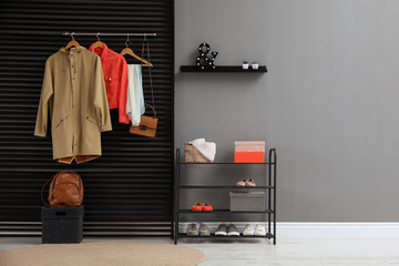 Hallway interior with stylish furniture, clothes and accessories