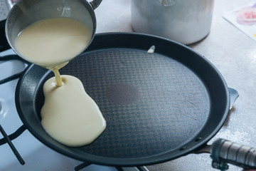 start preparing Breakfast. in the kitchen, pancakes are prepared on a non-stick pan. copy space