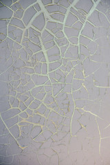 Dried gray paint on the door. Gray background, cracked paint on an old iron door
