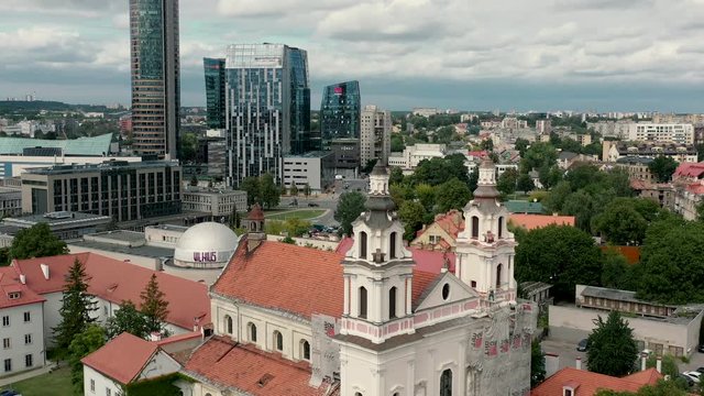 VILNIUS, LITHUANIA - JULY, 2019: Aerial view of the towers of church of Archangel Raphael near business city centers.