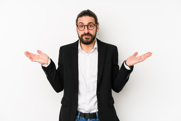 Young caucasian business man isolated on a white background confused and doubtful shrugging shoulders to hold a copy space.