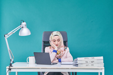 Office Lady with bundle of file on the table and laptop