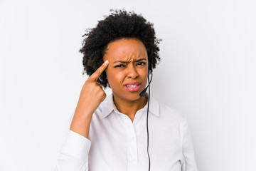 Young african american telemarketer woman isolated showing a disappointment gesture with forefinger.