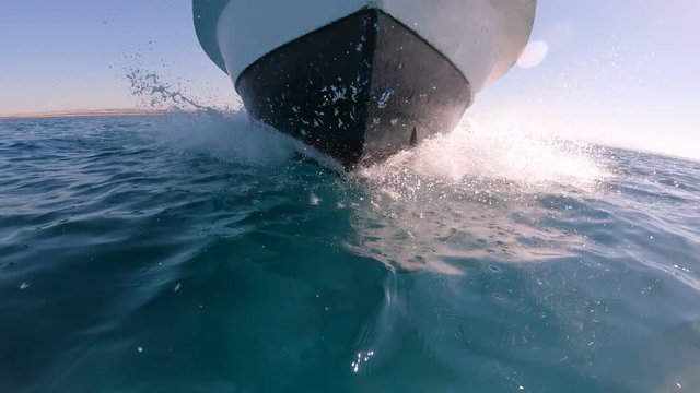Bow of a local fishing boat cutting through water of the Red Sea, sailing towards Umluj, a tropical island group in Saudi Arabia