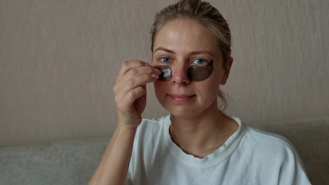young beautiful girl removes black eye patches