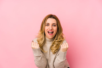 Fototapeta premium Young blonde cute woman wearing a sweater isolated cheering carefree and excited. Victory concept.