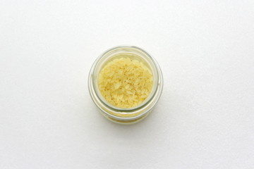 Glass jar with rice on a white background, top view