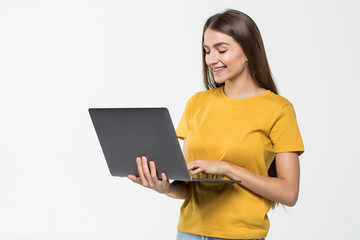 Fototapeta premium Portrait of a happy woman working on laptop computer isolated over white background