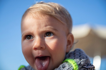 Portrait of cute toddler with her tongue out