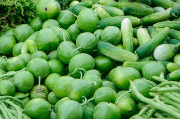 Young green fruits and vegetable on market stall. selective focus.