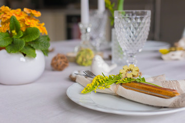 Easter festive spring table setting decoration, eggs in nest, selective focus, toned, top view