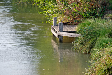 Fototapeta na wymiar Wooden peer on canal, France
