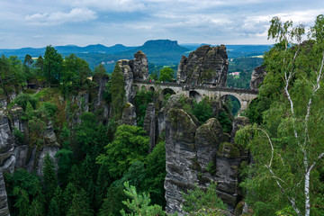 Fototapeta premium Famous bridge Basteibruecke in Saxon Switzerland on a cloudy day