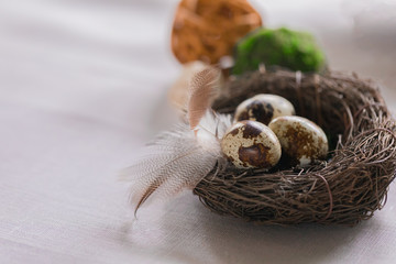 Easter festive spring table setting decoration, eggs in nest, selective focus, toned, top view