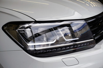 Headligth of a modern car close up. Modern technologies and solutions in the design of the car....