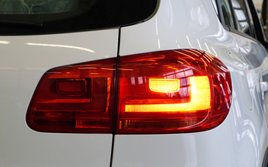 Red rear taillight of a modern car close-up. Service, repair, body repair, body painting, spare...