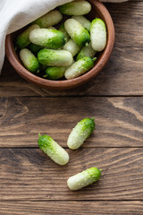Small snack cocktail Dutch cucumbers Quirk variety on wooden background