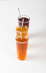Herbal fruit berry drink in a glass, pineapple with Basil, pomegranate with mint, sea buckthorn...