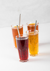 Herbal fruit berry cocktail in a glass, pineapple with Basil, pomegranate with mint, sea buckthorn with oregano