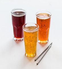 Herbal fruit berry cocktail in a glass, pineapple with Basil, pomegranate with mint, sea buckthorn with oregano