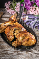 Quarters of fried chicken in a cast iron skillet.