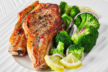 close-up of broiled pork rib chops on a plate