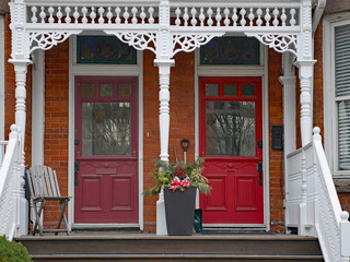 Porch of Victorian house with old elaborate wood spindle trim
