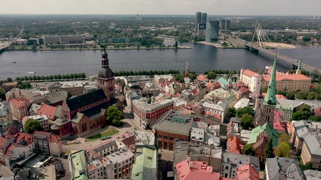 RIGA, LATVIA - MAY, 2019: Aerial view of the spiers Riga's cathedrales and roofs old city centre near the Daugava river.