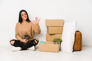 Woman moving home isolated on white background smiling cheerful showing number five with fingers.
