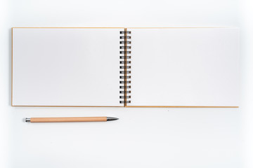 Brown spiral notebook isolated on white background.top view