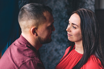 A pregnant girl together with her beloved poses and rejoices in pregnancy. Happy moments