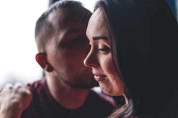 Obraz premium A pregnant girl together with her beloved poses and rejoices in pregnancy. Happy moments