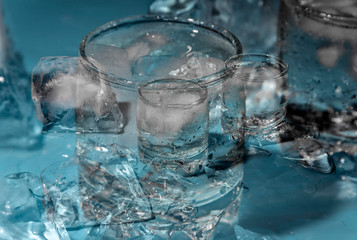 Abstract background with glass of cold water with ice.