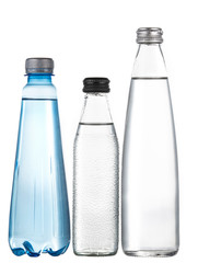 Glass and plastic bottles of fresh drinking water