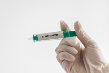 Obraz premium Coronavirus COVID-19 SARS virus vaccination cure medicine gloved hand hospital epidemic pandemic laboratory