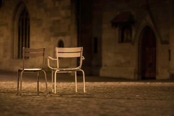 Two empty chairs on Zurich streets. Night scenery