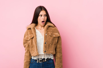 Young cute woman being shocked because of something she has seen.