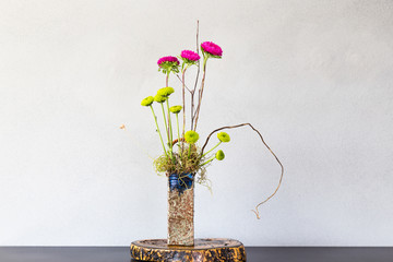 Japanese style flower arrangement Ikebana isolated on white background
