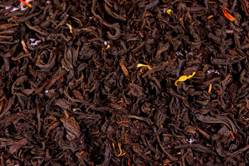 Dried tea leaves as a background. Homogeneous filling. Tea for breakfast. Fragrant tea. A lot of tea.