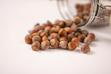 hazelnuts spilled from jar close up