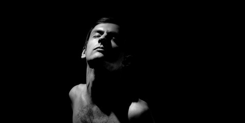 Fototapeta premium expressive photo, black and white portrait of a guy, with hard light