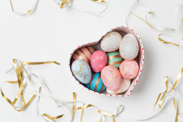 Cardboard box with colorful Easter eggs on white background. Happy Easter