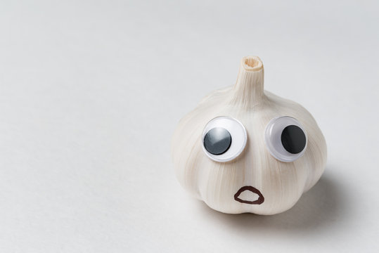 garlic character. Garlic with Googly eyes and funny face on white background