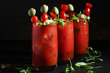Three glasses with Bloody Mary cocktail	
