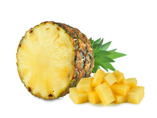 Ripe halved pineapple next to heap of juicy chunks isolated on white background