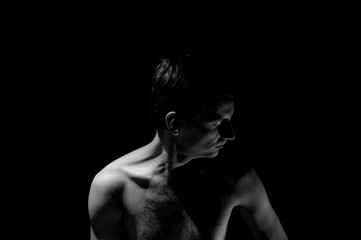 Fototapeta na wymiar expressive photo, black and white portrait of a guy, with hard light