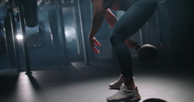 Young confident determined girl working out in gym, doing power sit-ups with weights. Multiethnic model staying fit and bodybuilding, achieving goals 4k footage