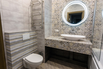 The interior of a modern bathroom combined with a toilet